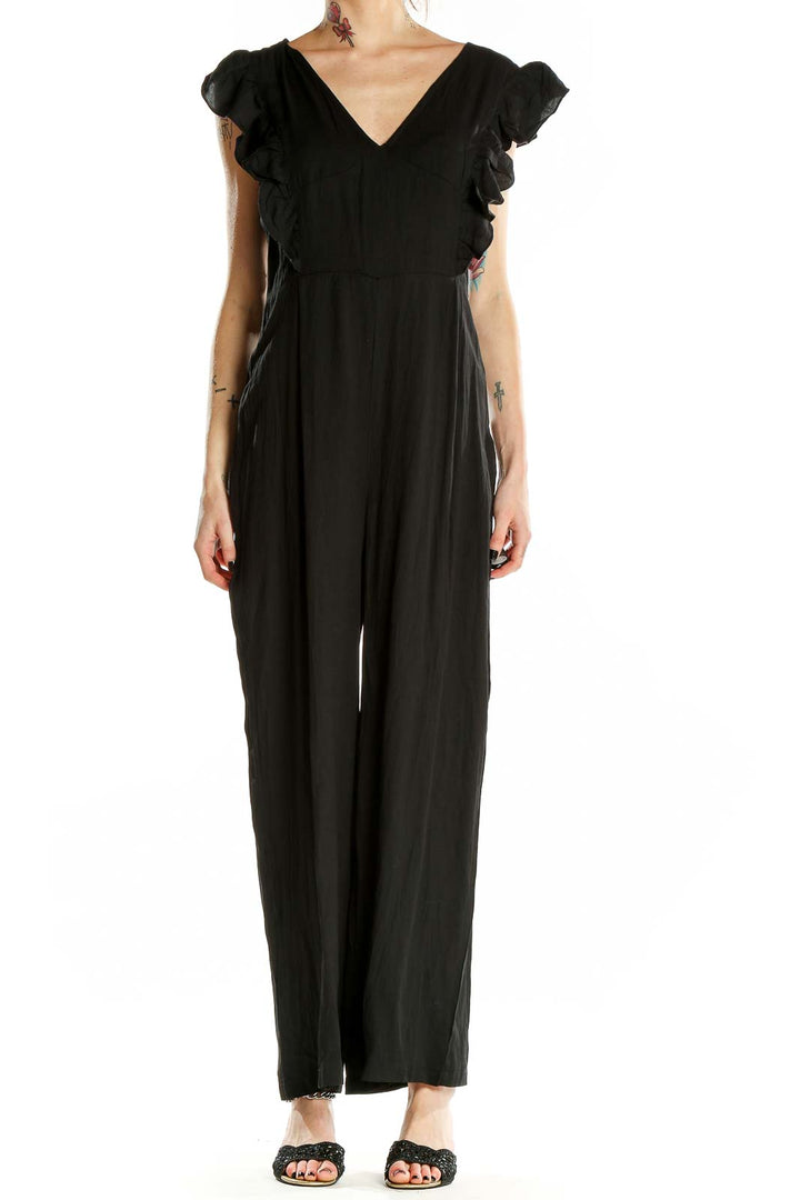 Front view of black SilkRoll jumpsuit with V-neck and ruffle sleeves