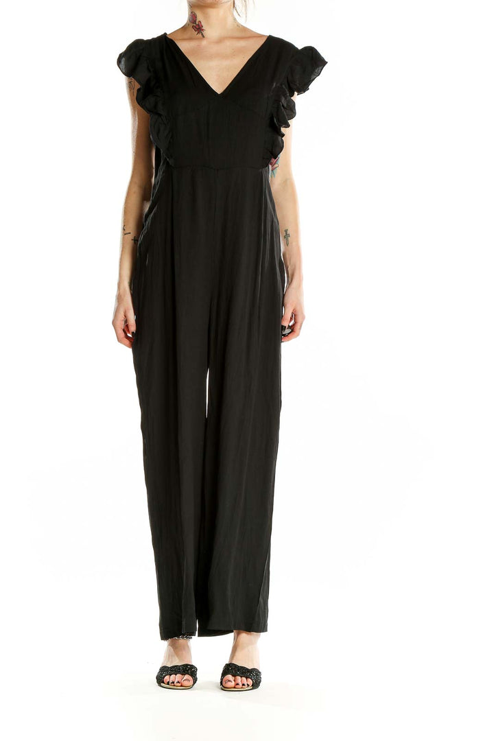 Front view of black SilkRoll jumpsuit with V-neck and ruffle sleeves