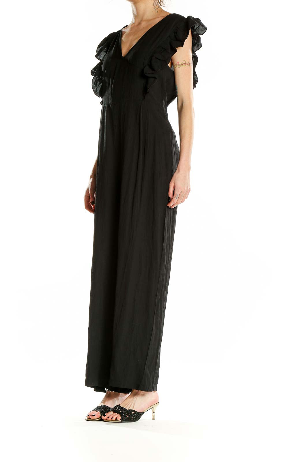 Front view of black SilkRoll jumpsuit with V-neck and ruffle sleeves