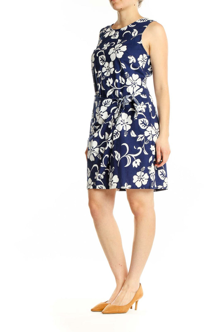 Front view of Shannon Marie navy and white floral print sleeveless cotton dress with side tie