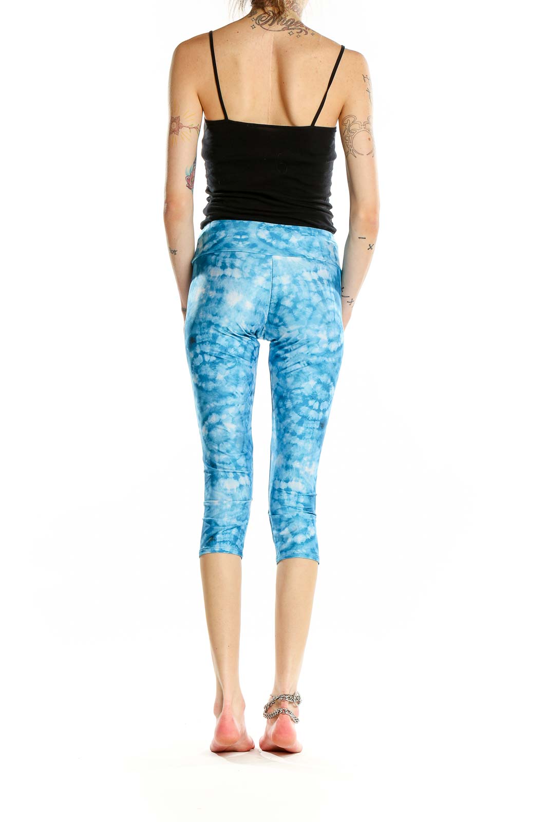 Back view of Onzie blue tie-dye capri yoga leggings on model