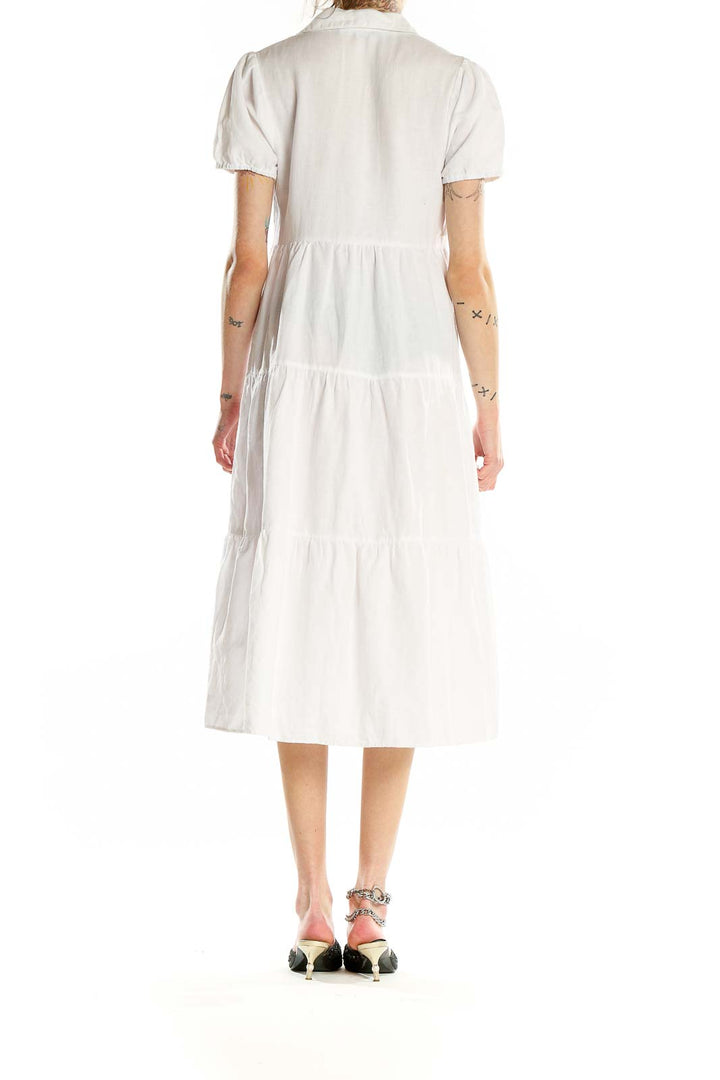 Back view of Zara white tiered cotton-linen midi dress showing full skirt and short sleeves