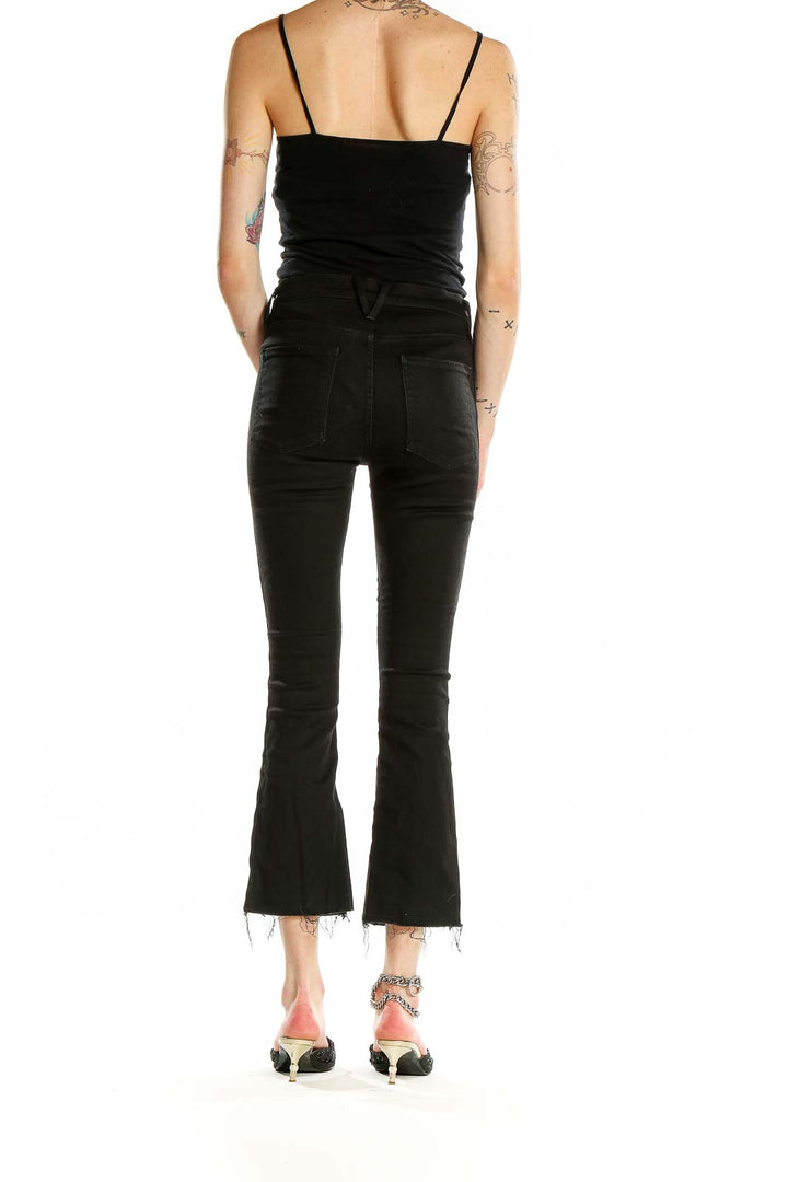 Back view of Veronica Beard black high-waisted cropped flare jeans on model