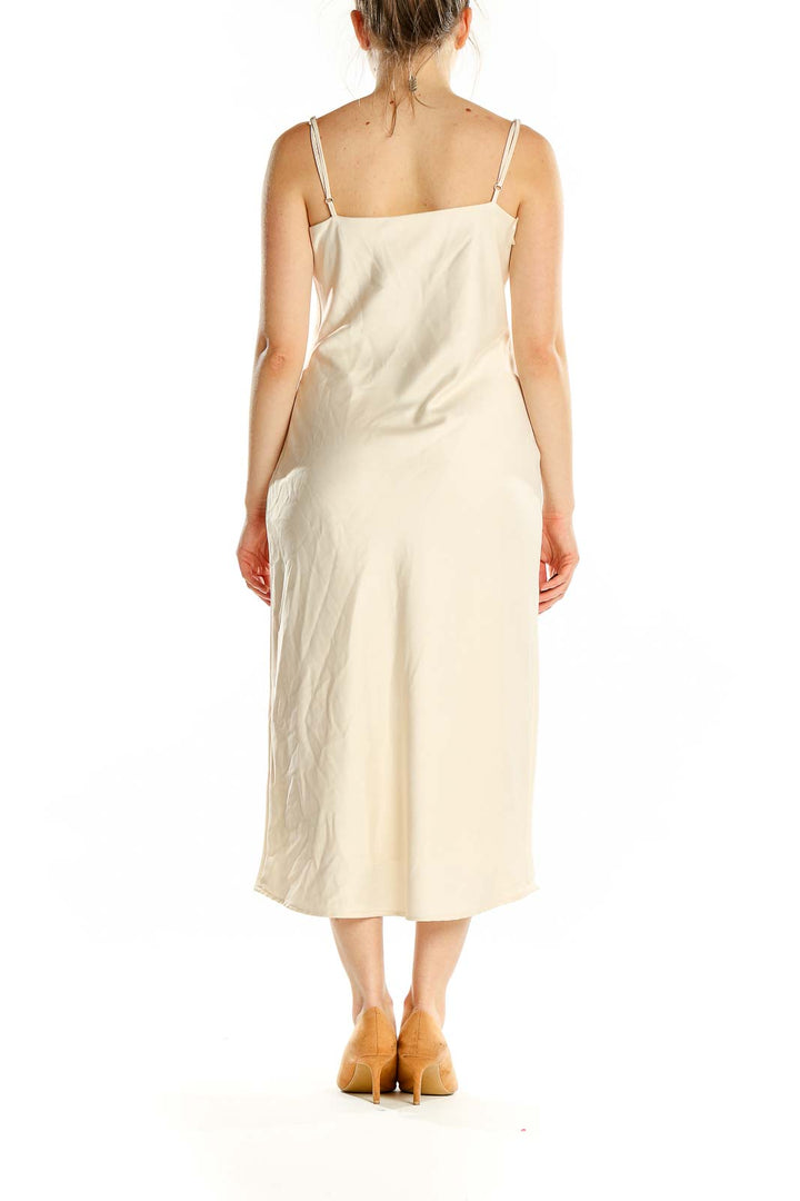 Back view of Birdy Grey cream satin slip midi dress showing sleek silhouette