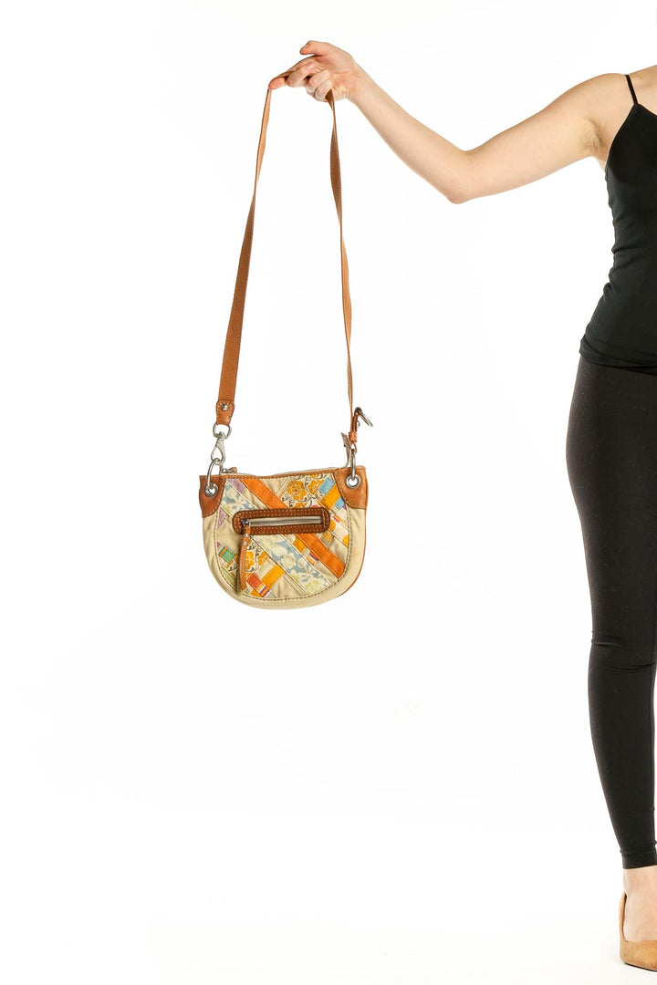 Front view of Fossil beige patchwork shoulder bag with orange accents