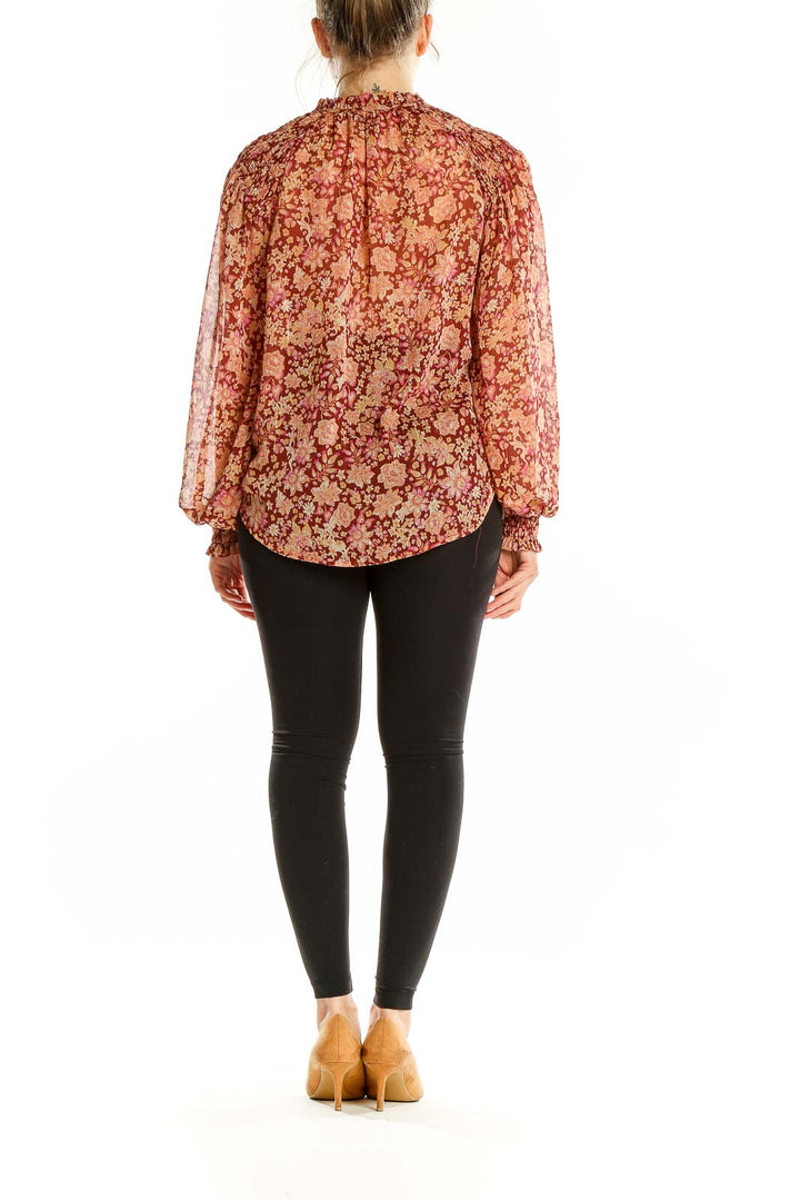 Back view of Joie burgundy floral print sheer blouse showing billowing sleeves