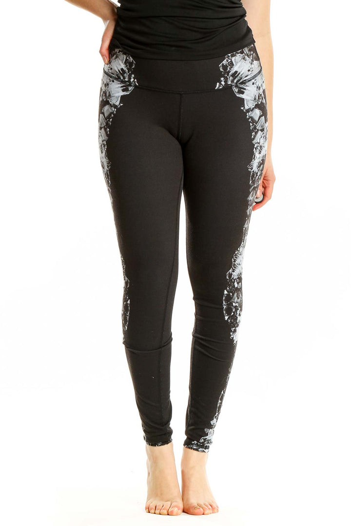 Front view of Alo black athletic leggings with floral side prints