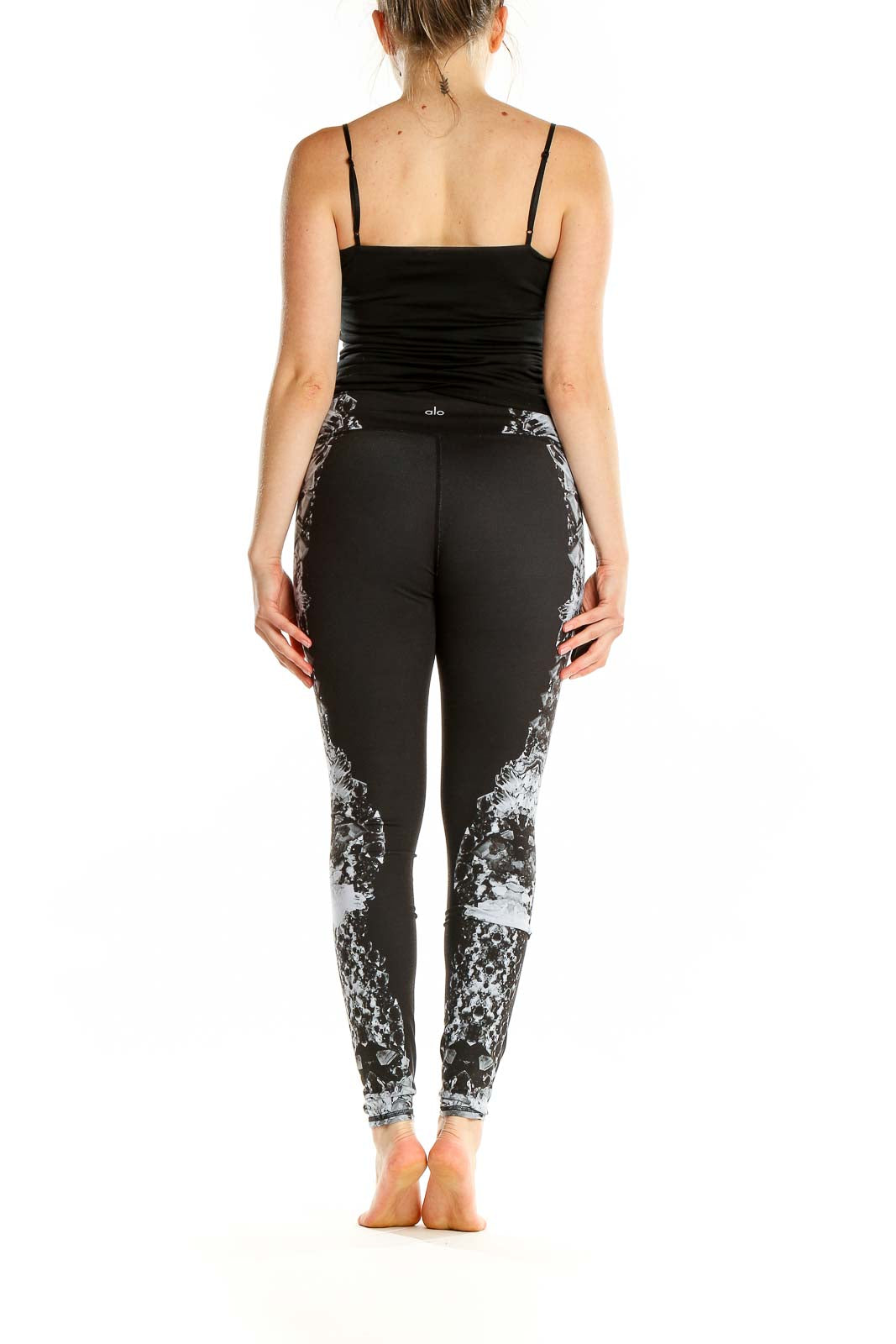 Back view of Alo black athletic leggings showing floral print detail