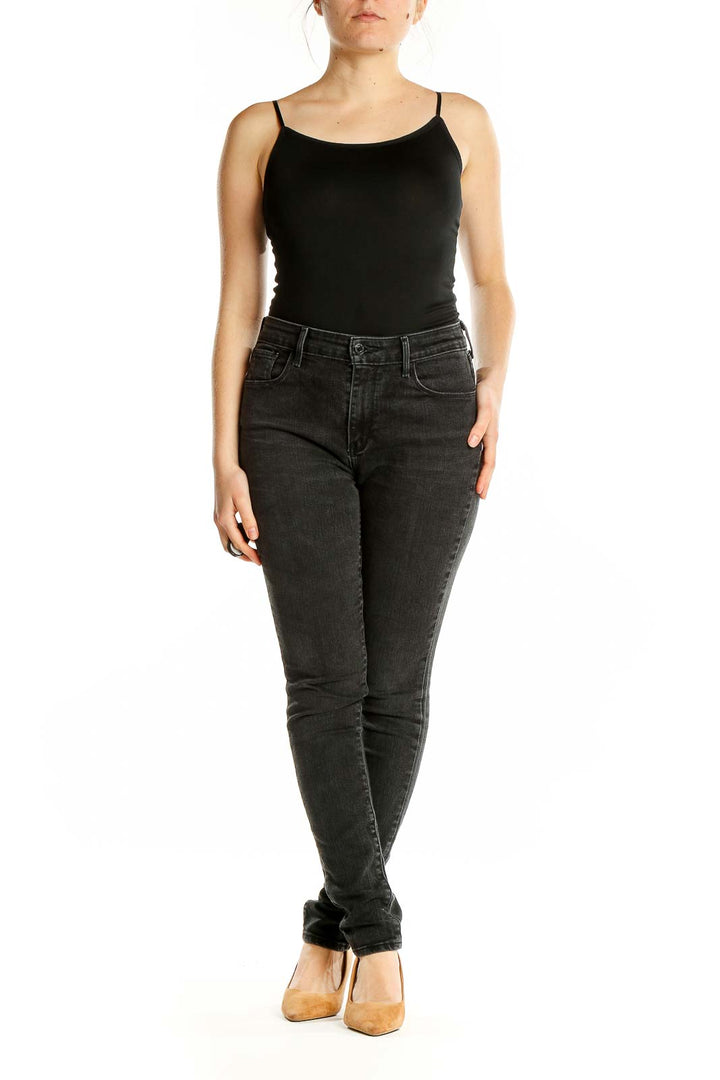 Front view of Levi's black slim fit jeans on model