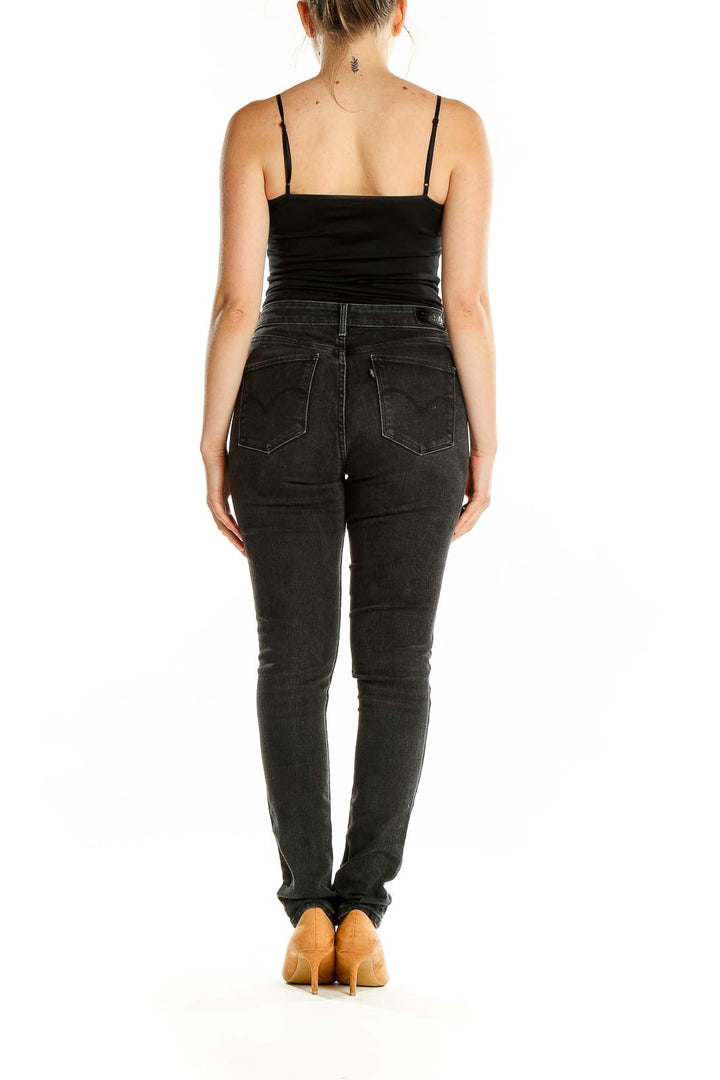 Back view of Levi's black slim fit jeans on model