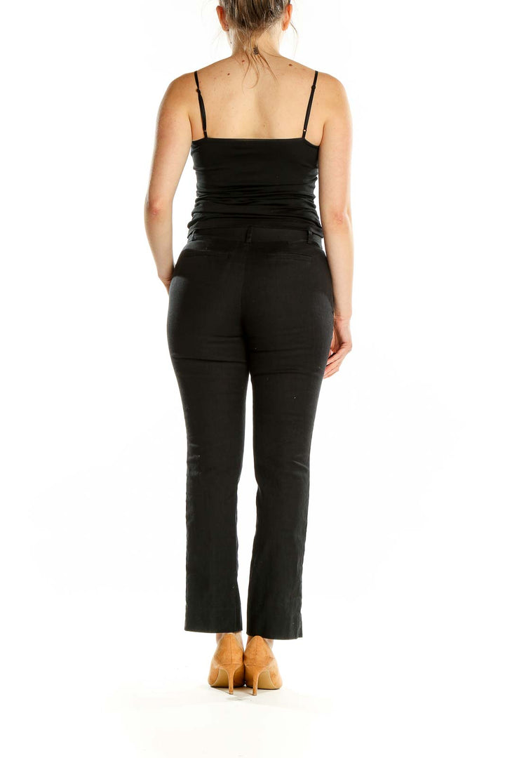 Back view of Diane von Furstenberg black straight leg trousers on model