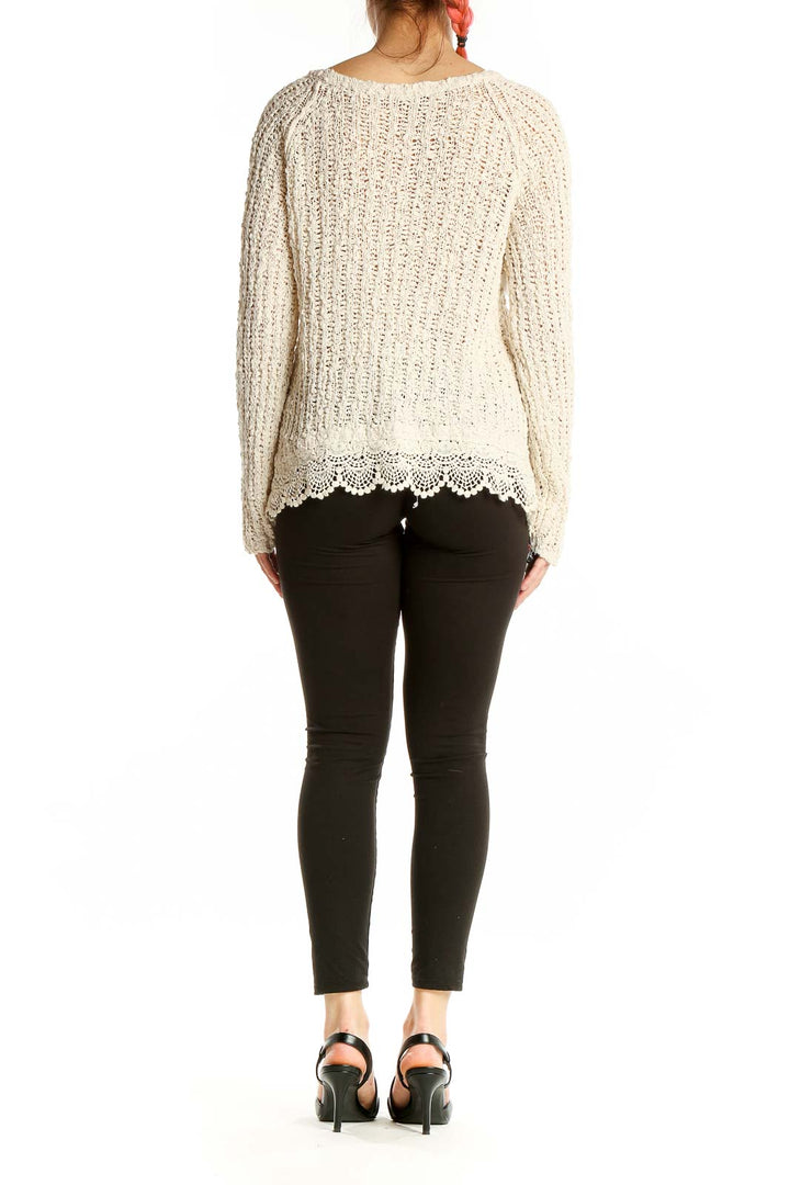 Back view of cream knitted cotton sweater with lace trim by KNITTED & KNOTTED