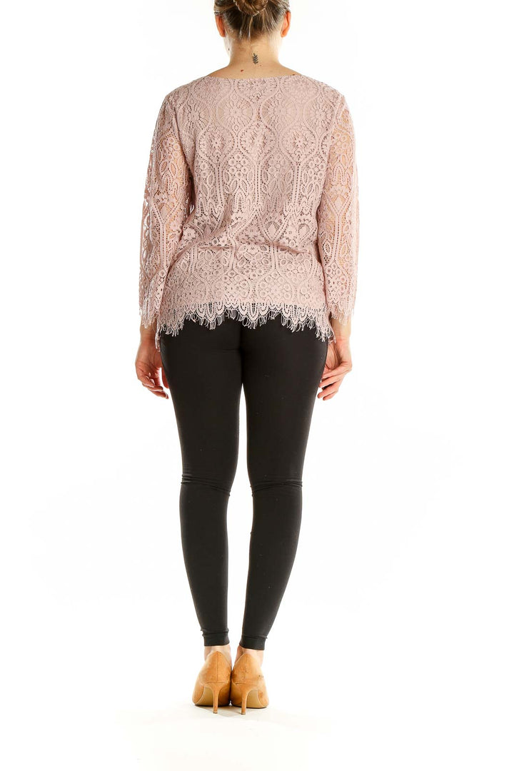 Back view of Ann Taylor LOFT blush pink lace top showing intricate lace pattern