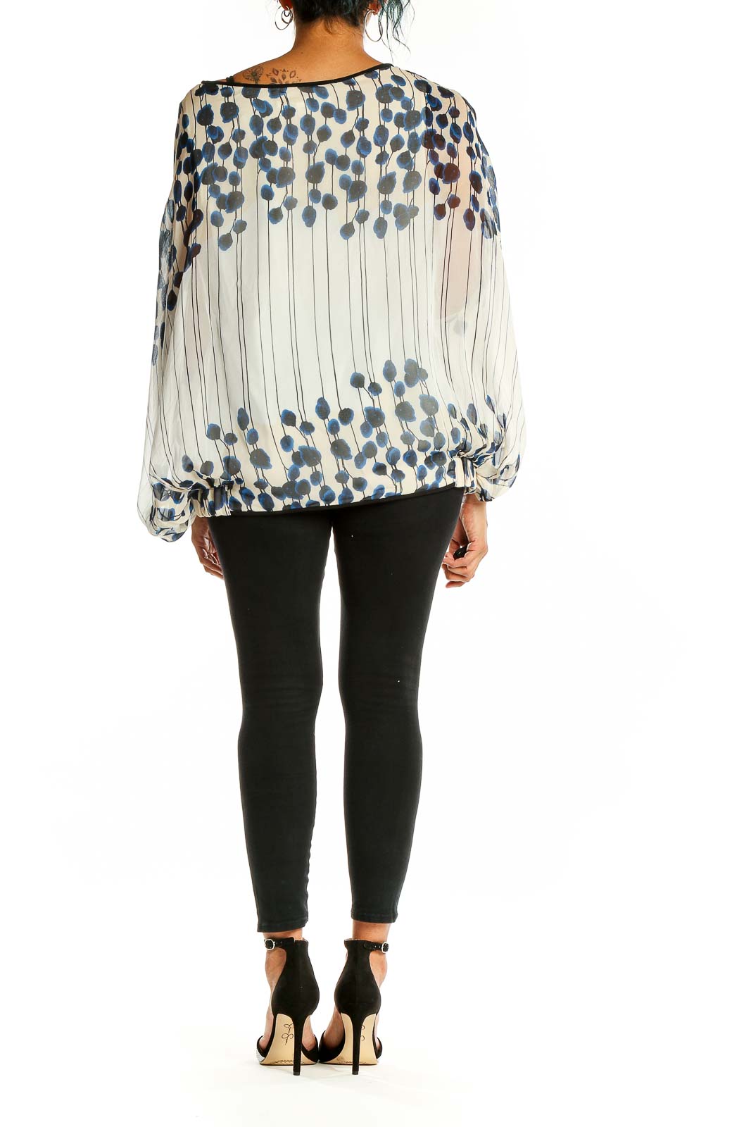 Back view of white sheer blouse with navy floral print by Diane von Furstenberg