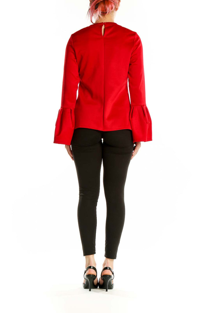 Back view of red Halogen blouse showing keyhole detail and bell sleeves