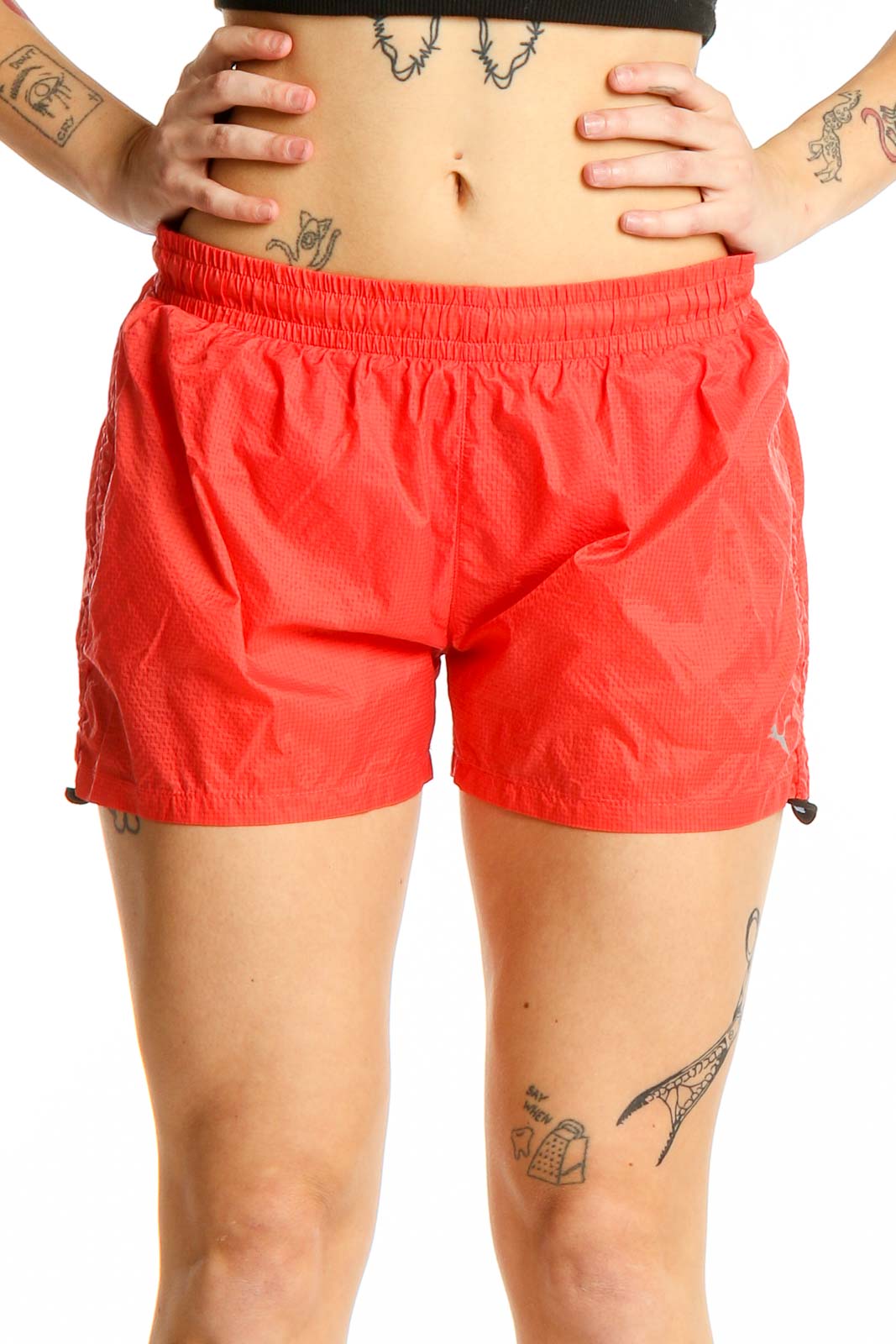 Front view of red Puma athletic shorts with elastic waistband