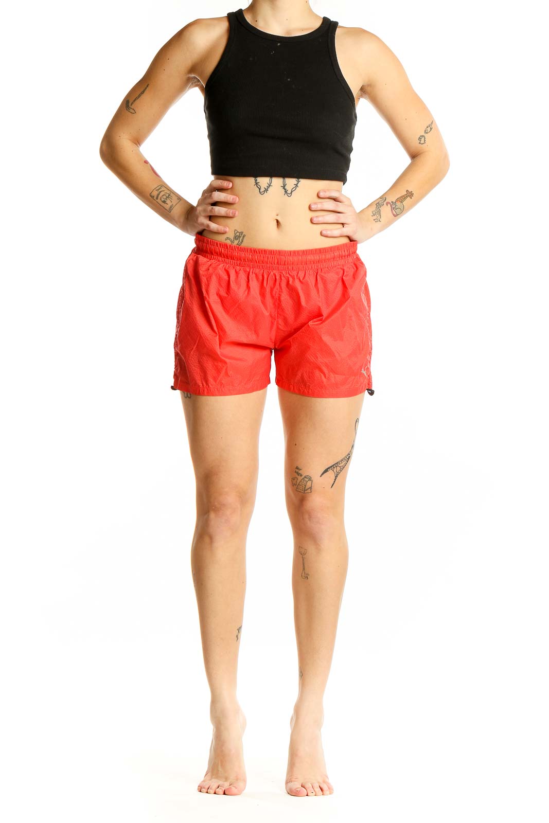 Front view of red Puma athletic shorts with elastic waistband