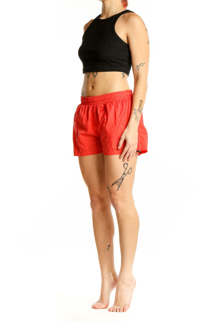 Front view of red Puma athletic shorts with elastic waistband