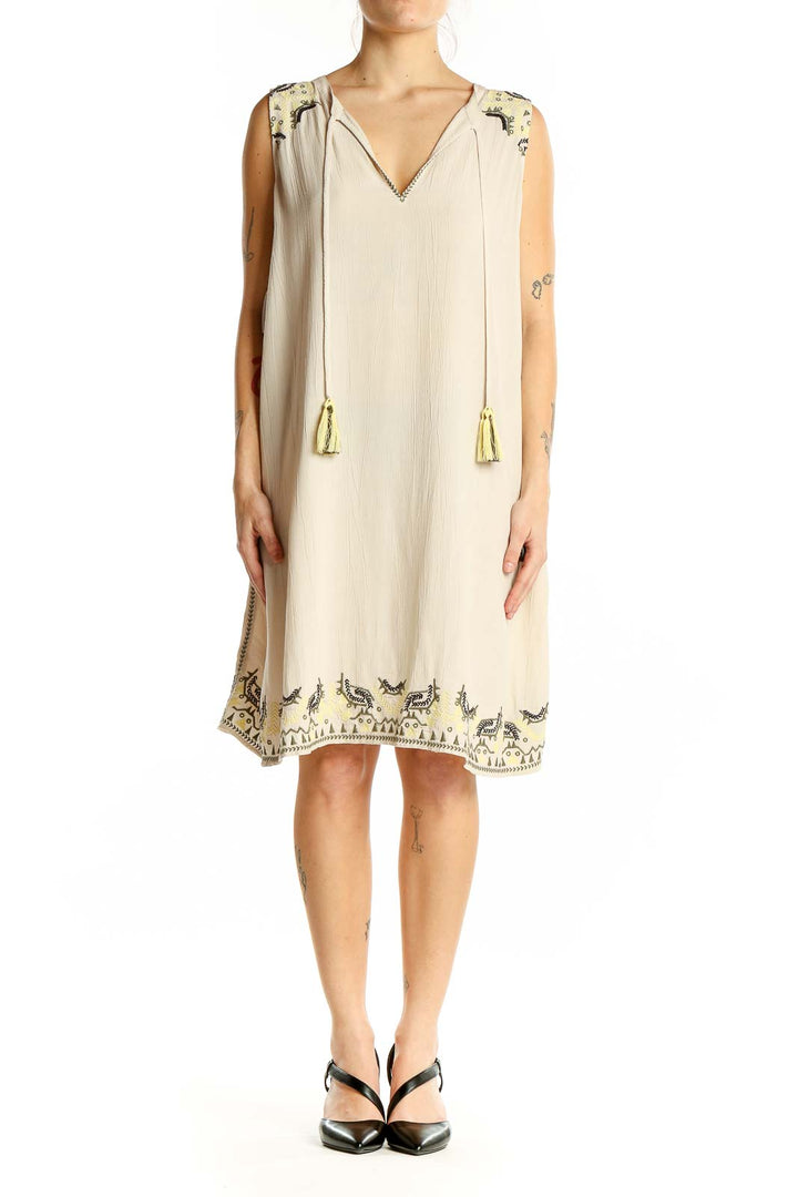 Front view of beige LOFT Outlet LOUNGE sleeveless shift dress with black embroidery