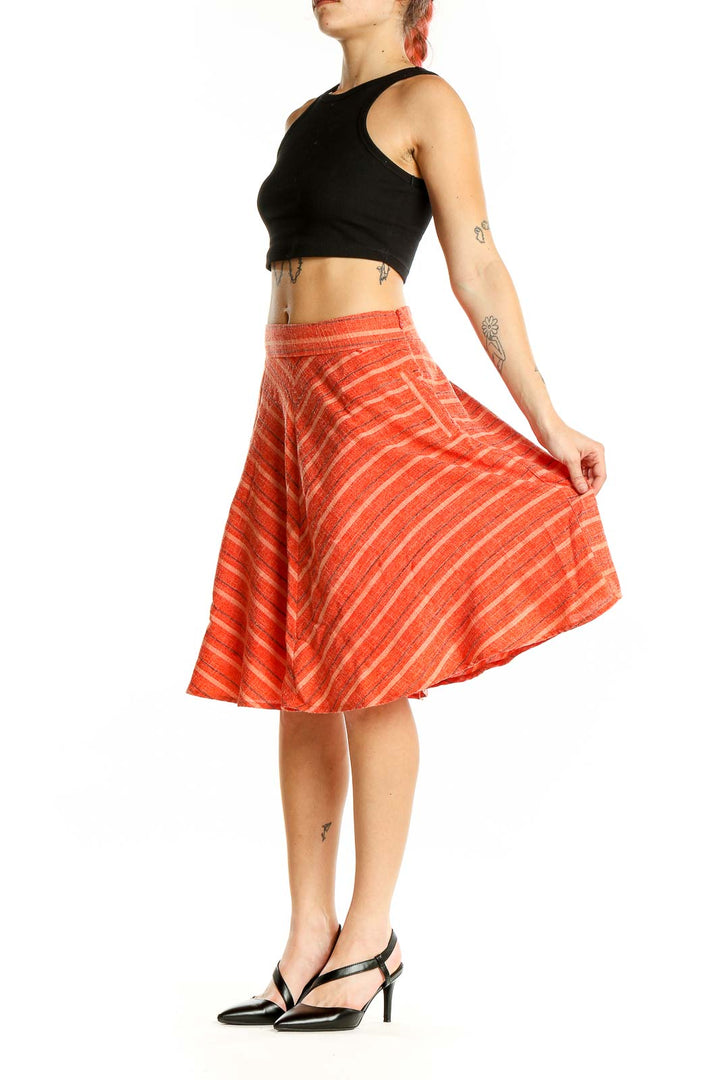 Front view of Harlyn orange striped A-line midi skirt with chevron pattern