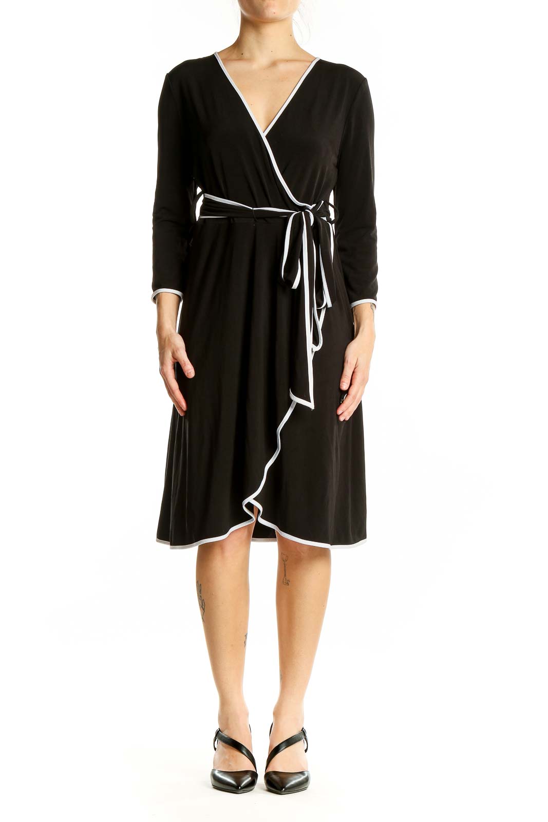 Front view of Calvin Klein black wrap dress with white trim and adjustable waist tie