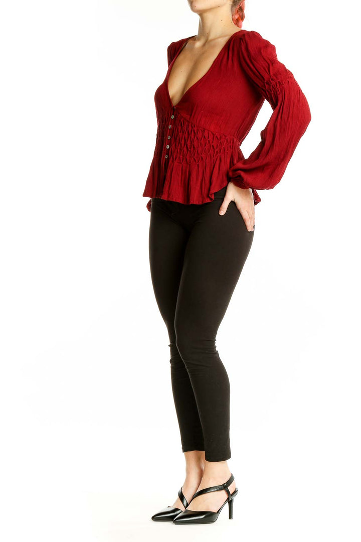 Front view of red rayon smocked peplum top from Free People