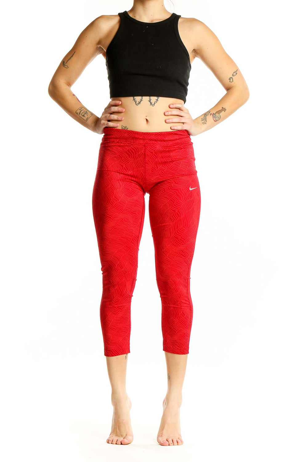 Front view of red textured Nike capri leggings on model