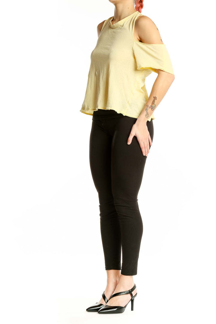 Front view of yellow cold shoulder cotton top by WE THE FREE