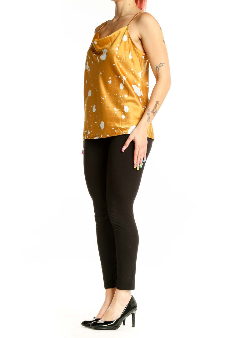 Front view of Nine West golden camisole with white splatter print