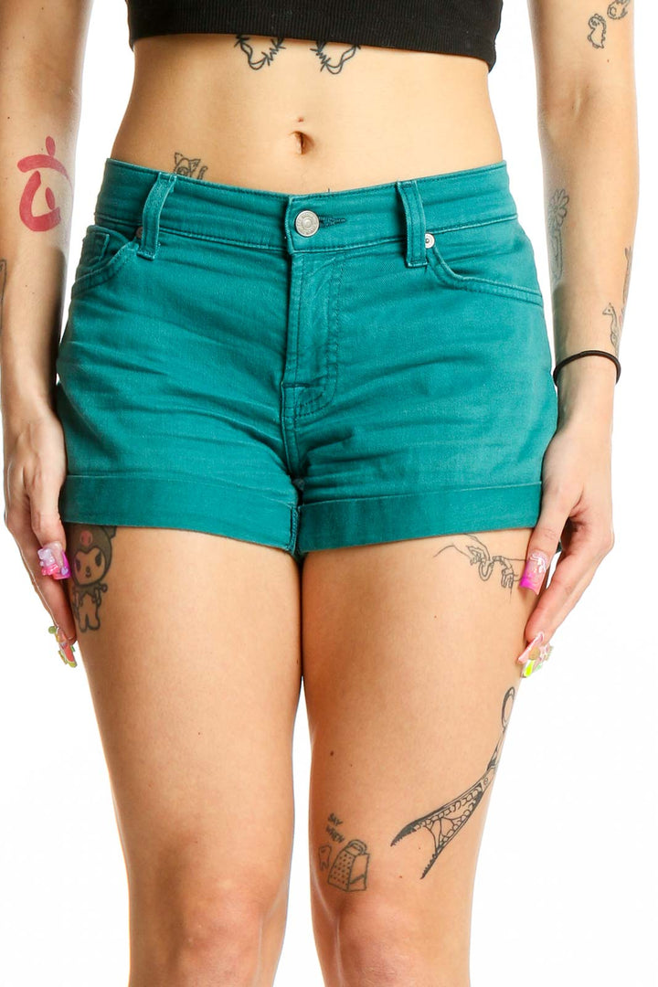 Front view of teal cuffed shorts by 7 For All Mankind