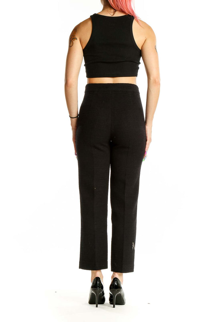 Back view of Zara black high-waisted tailored trousers on model