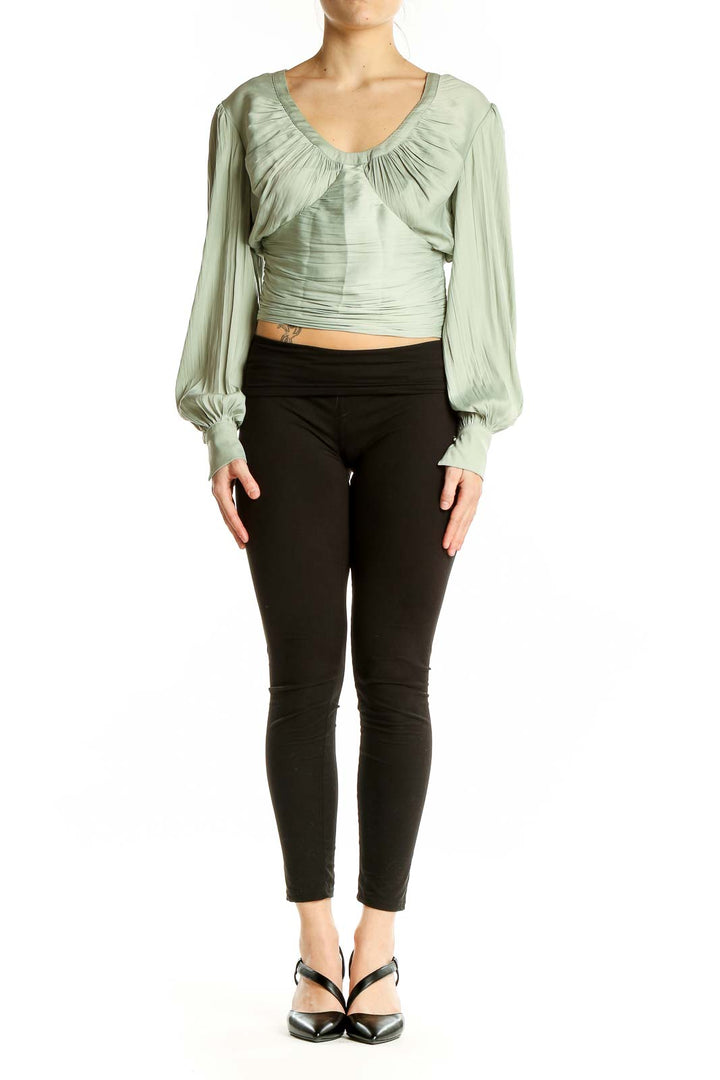 Front view of Anthropologie sage green crop top with ruched design and balloon sleeves