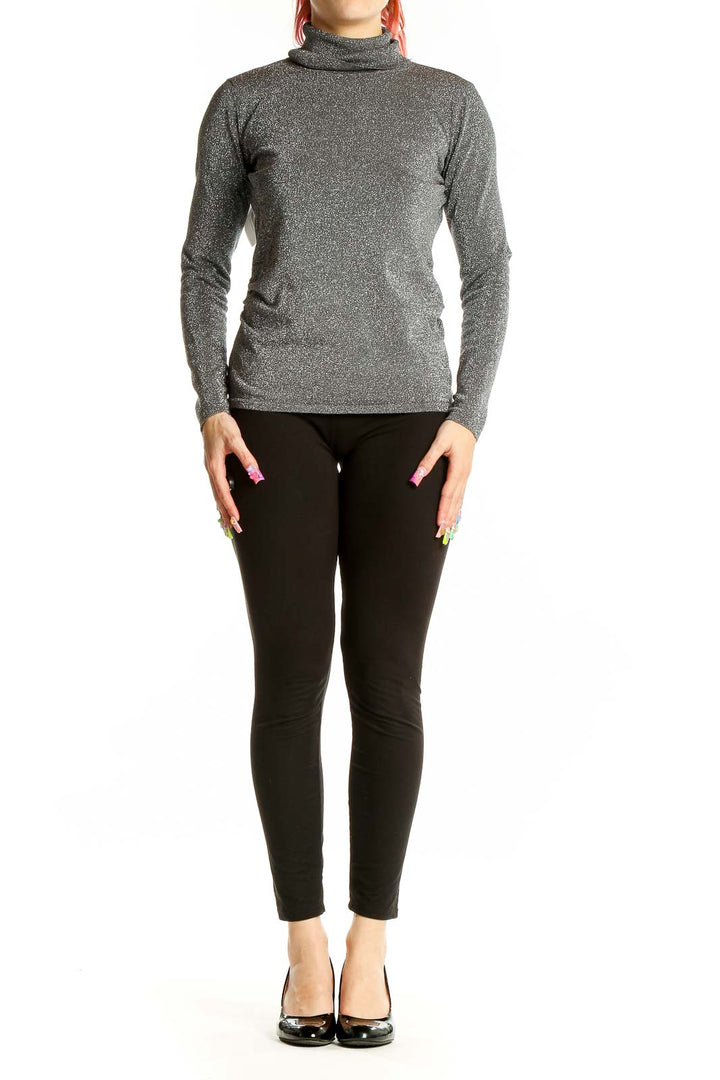 Front view of Chelsea & Theodore metallic gray turtleneck sweater on model