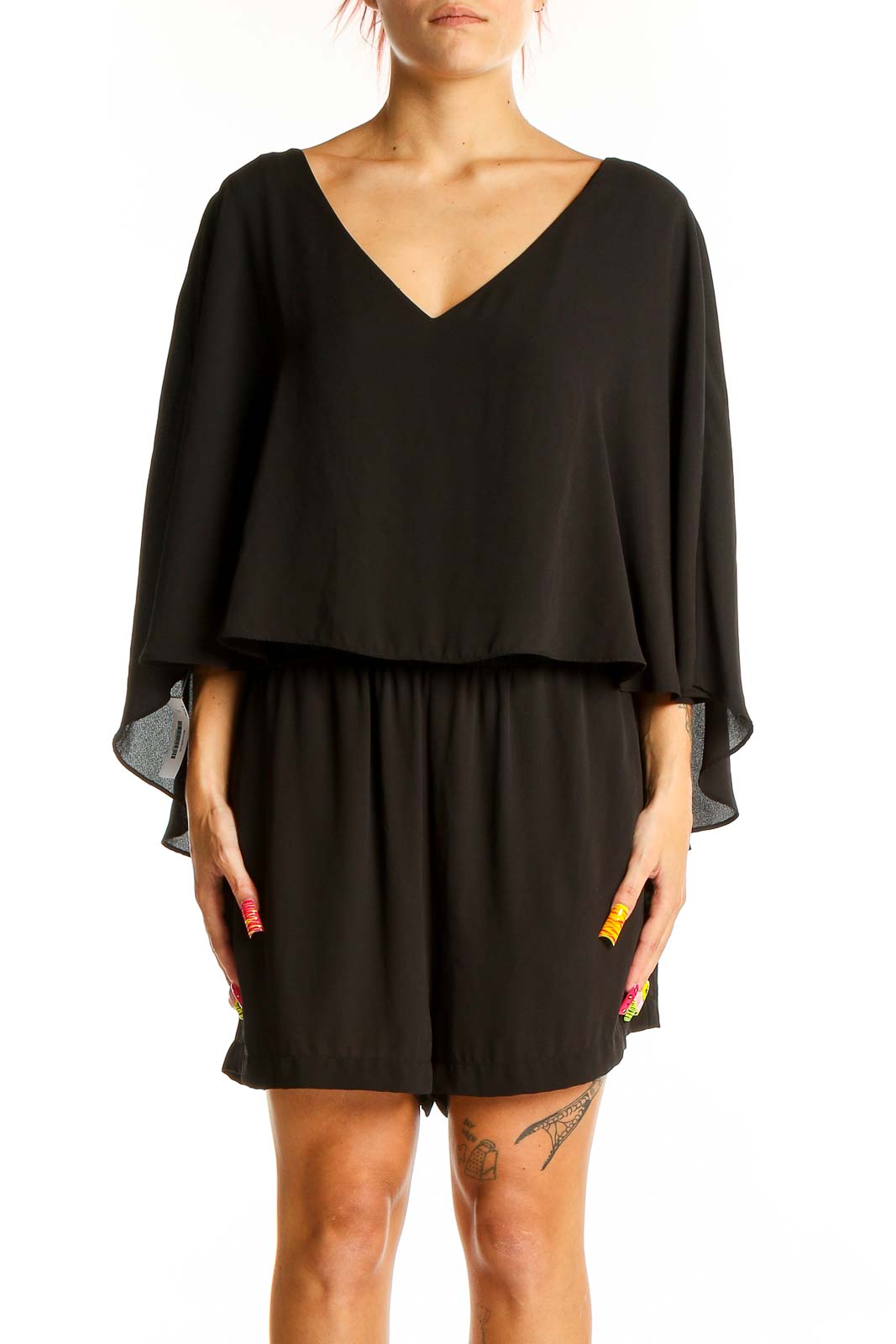 Front view of black cape-style romper by BCBG MaxAzria with V-neckline