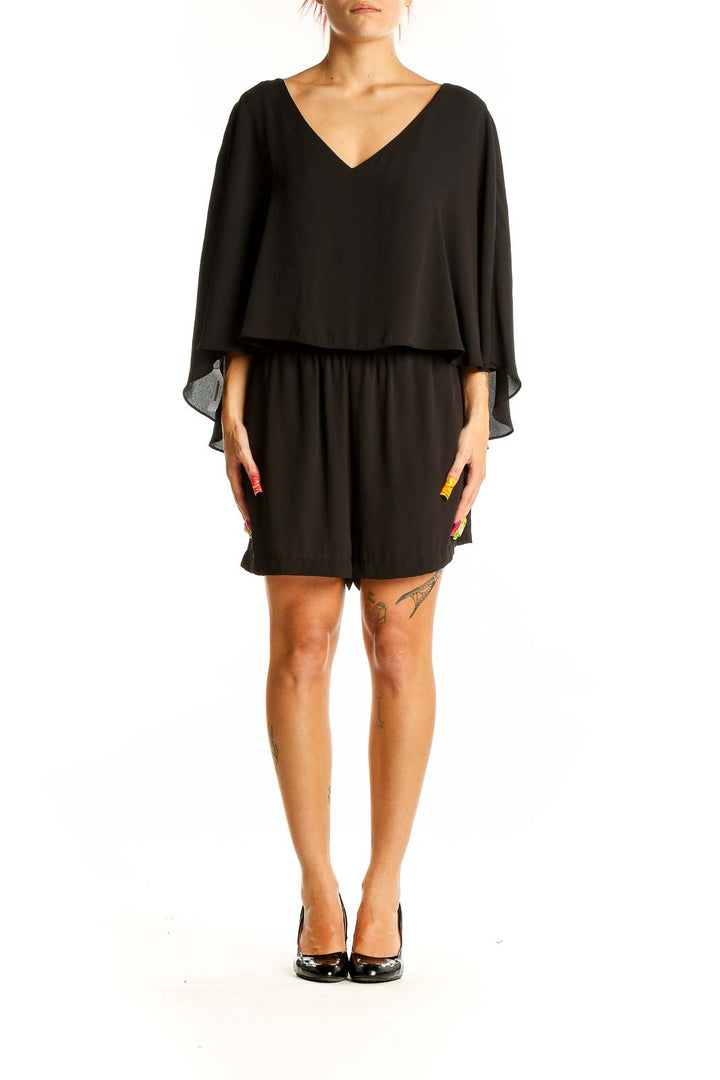 Front view of black cape-style romper by BCBG MaxAzria with V-neckline