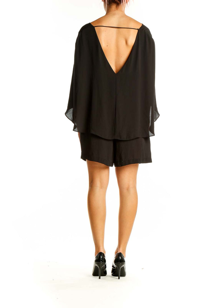 Back view of BCBG MaxAzria black romper showing open back design