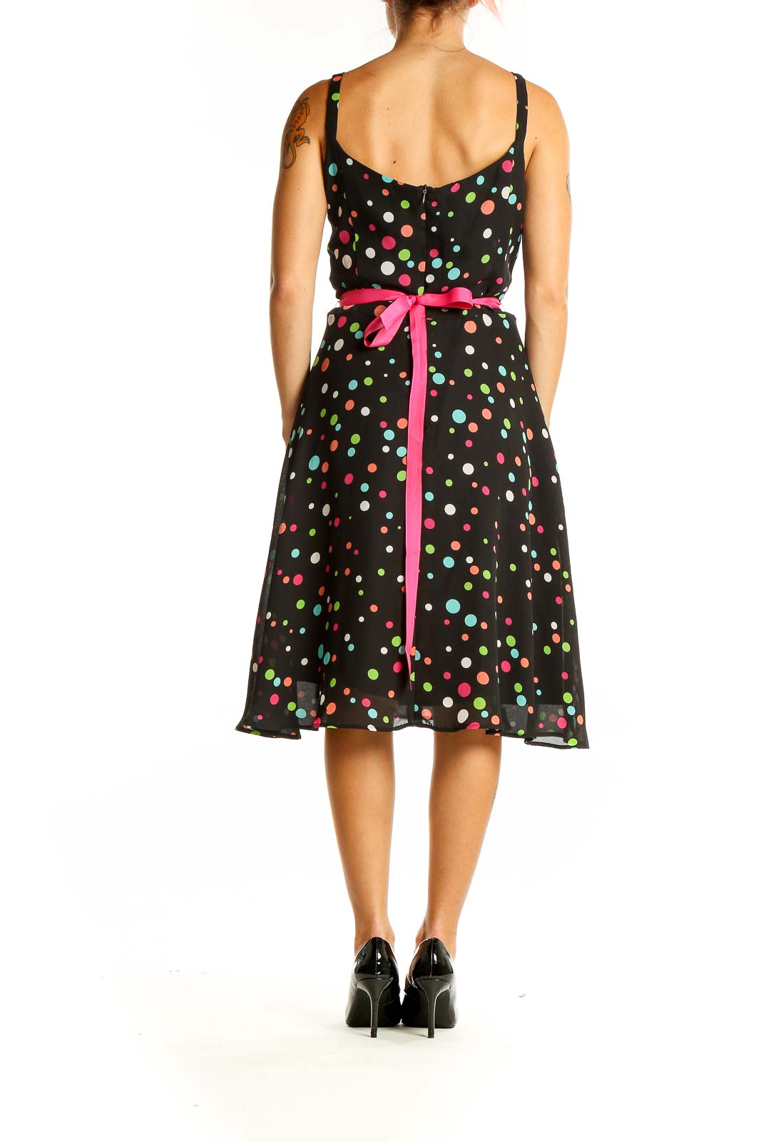 Back view of K & Company black polka dot sleeveless dress showing tie-back detail