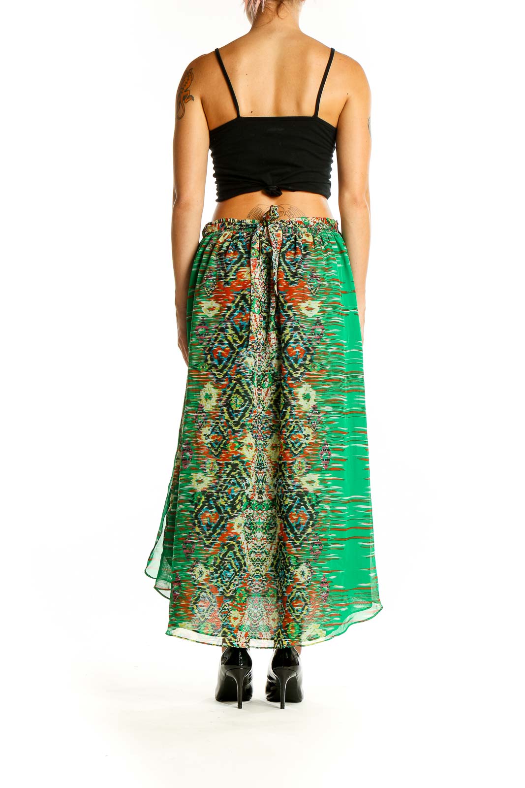 Back view of green patterned INC maxi skirt showing flowing silhouette