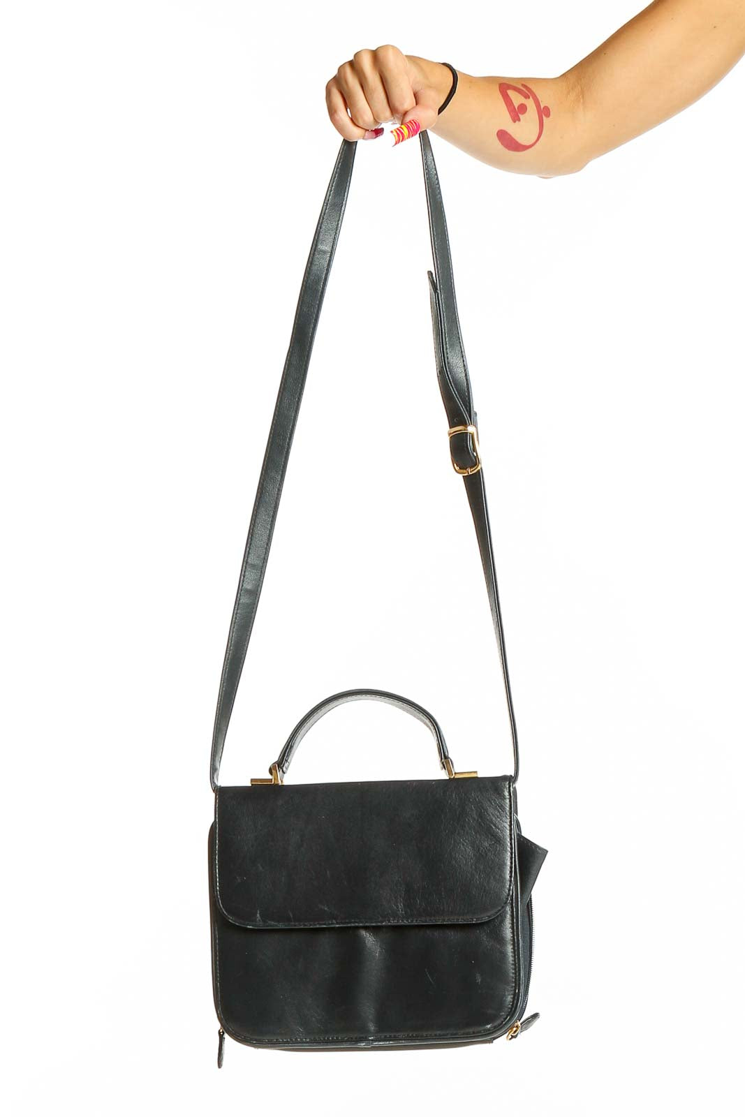 Front view of black leather Coletta crossbody bag held by model's arm