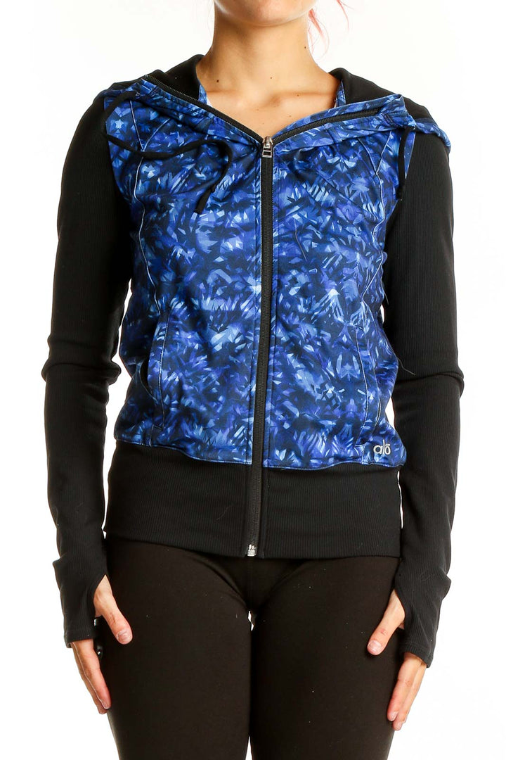 Front view of Alo Yoga blue patterned activewear jacket with black sleeves