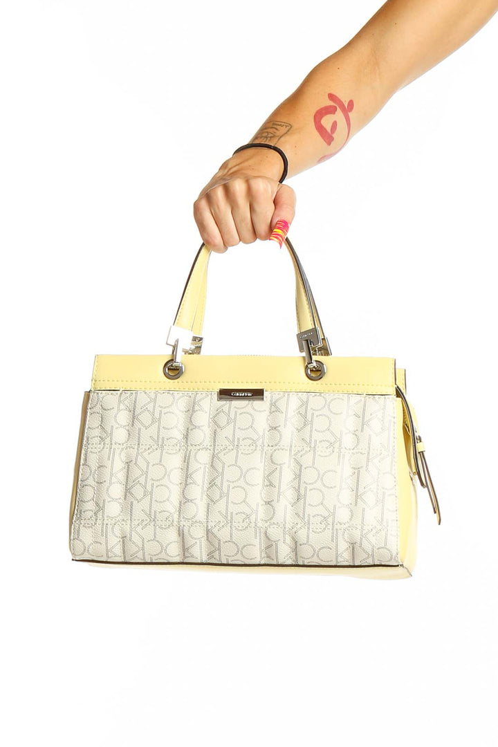 Front view of Calvin Klein cream and yellow monogram satchel