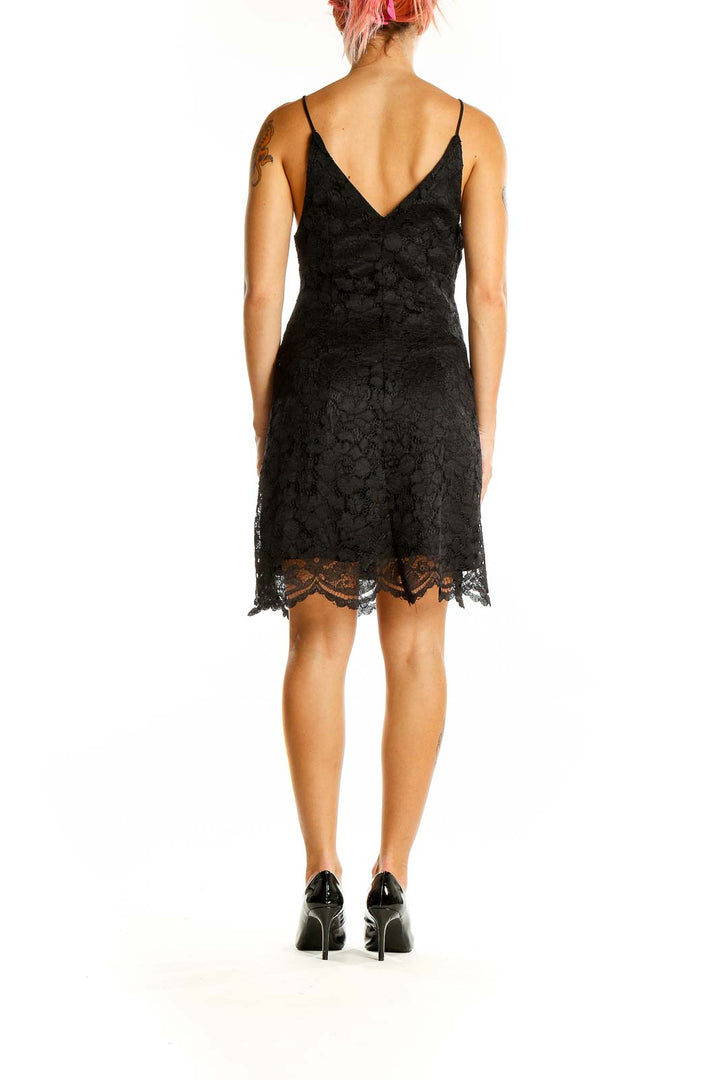 Back view of Leith black lace mini dress showing low V-back