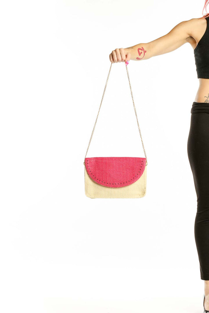 Front view of Escada Sorbetto Rosso pink and beige woven straw crossbody bag