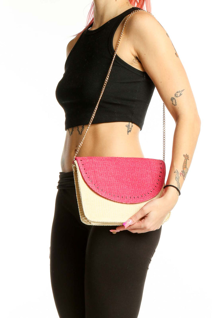 Front view of Escada Sorbetto Rosso pink and beige woven straw crossbody bag