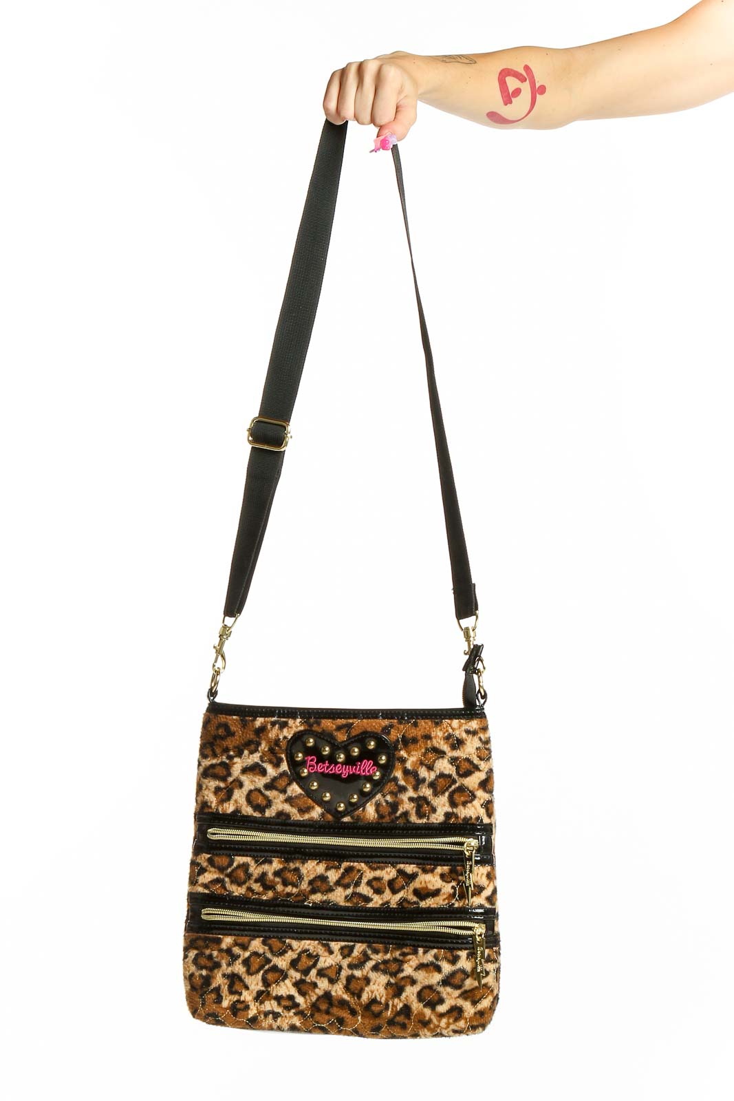 Front view of Betsey Johnson leopard print crossbody bag with zipper details