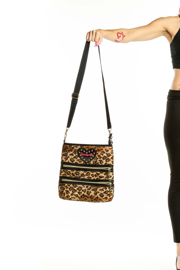 Front view of Betsey Johnson leopard print crossbody bag with zipper details