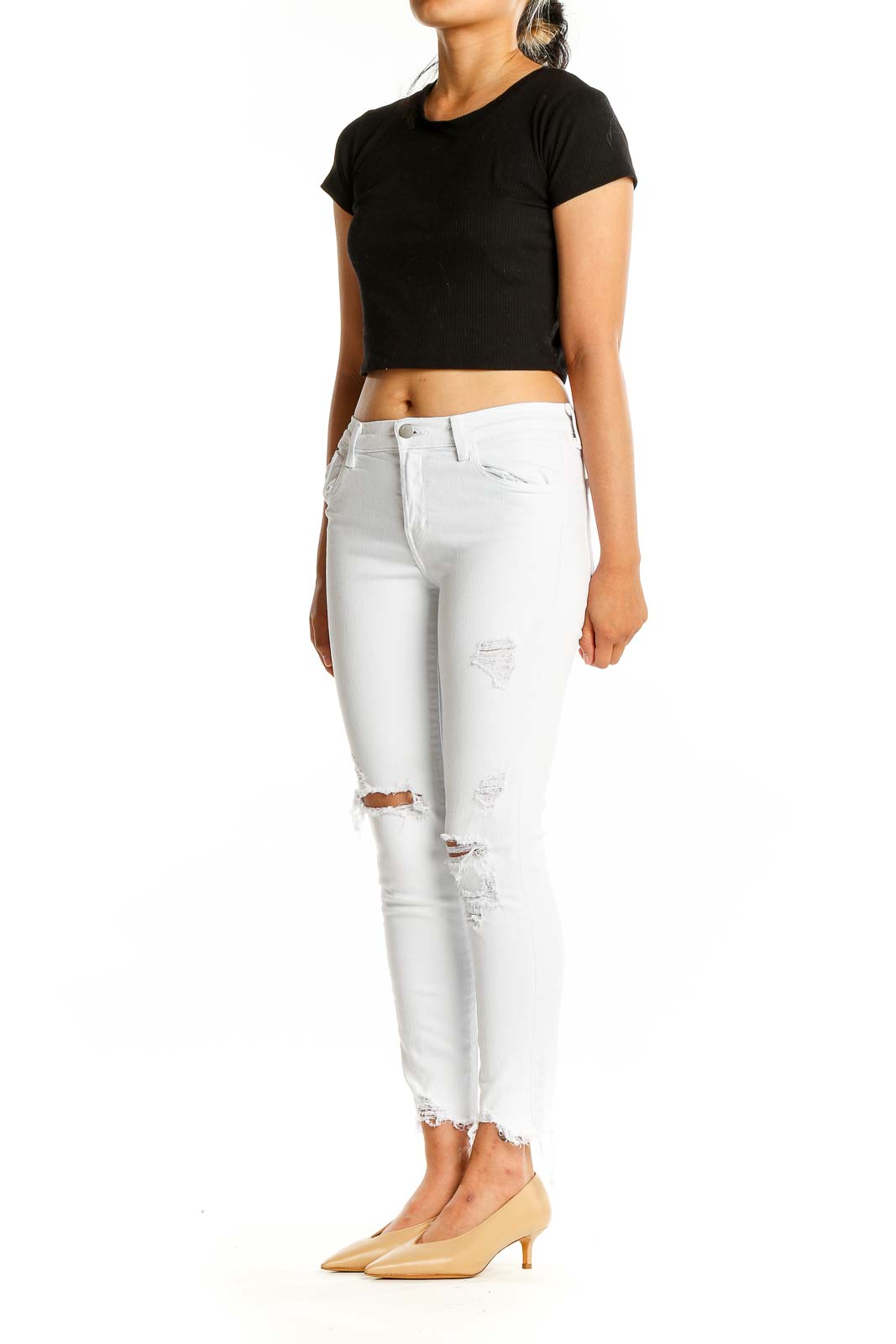 Front view of J Brand white distressed skinny jeans with ripped knees