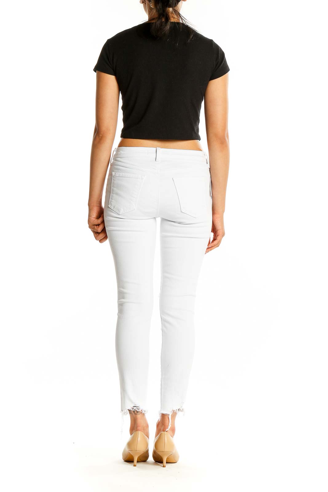 Back view of J Brand white distressed skinny jeans showing pocket design