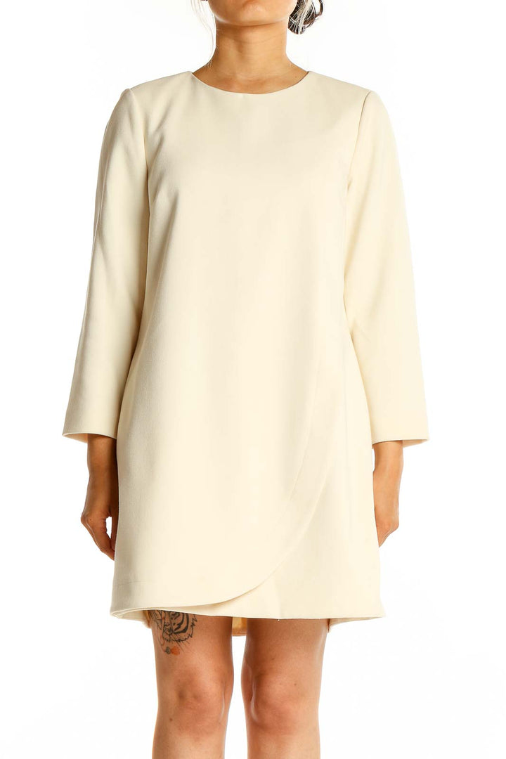 Front view of J.Crew cream shift dress with long sleeves