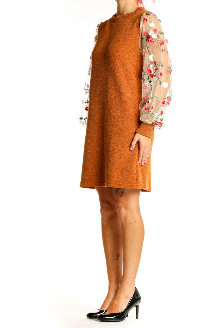 Front view of orange knit dress with floral mesh sleeves